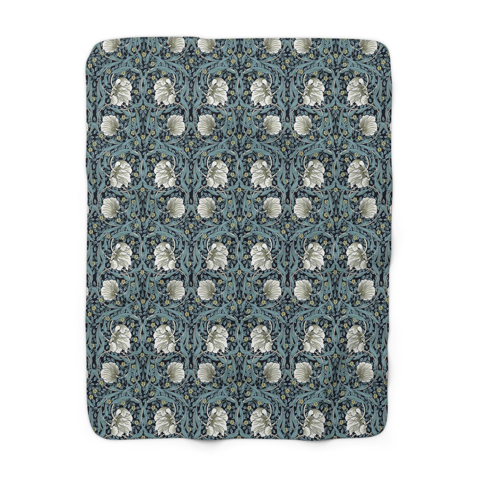 A plush fleece blanket with a geometric William Morris & Co pattern in a slate blue colour, featuring a dense, cozy texture.