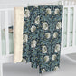 A plush fleece blanket with a geometric William Morris & Co pattern in a slate blue colour, featuring a dense, cozy texture.