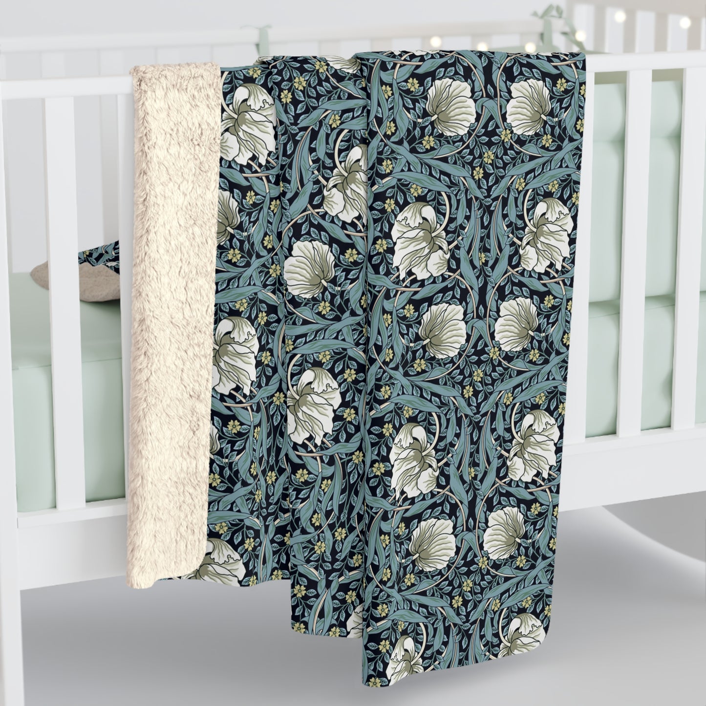 A plush fleece blanket with a geometric William Morris & Co pattern in a slate blue colour, featuring a dense, cozy texture.