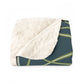 A Sherpa fleece blanket with a floral and swan William Morris & Co pattern in white and green colours on a dark background.