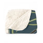 A Sherpa fleece blanket with a floral and swan William Morris & Co pattern in white and green colours on a dark background.