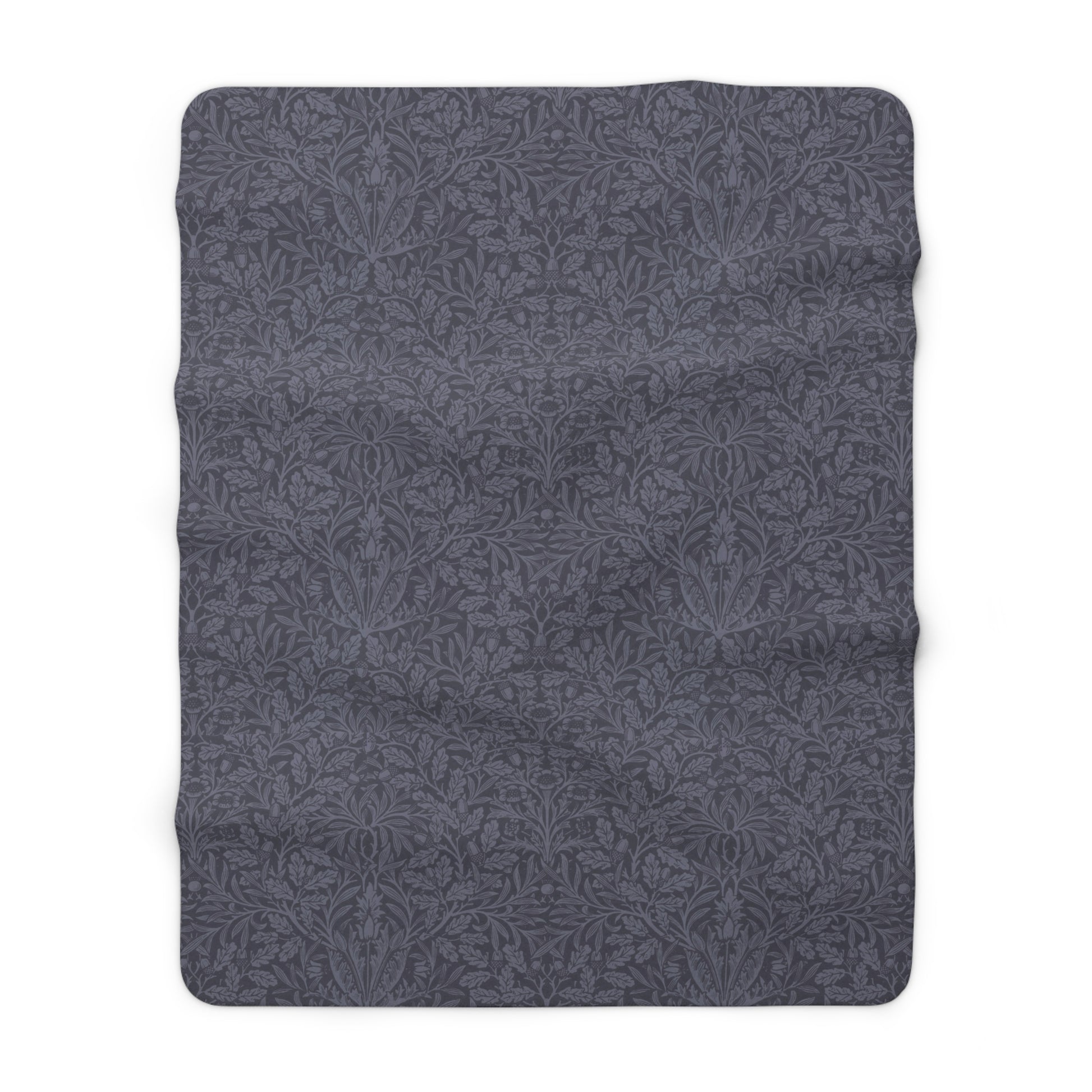 A smoky blue Sherpa fleece blanket with a floral pattern, made inspired by William Morris' Acorn and Oak Leaves collection.
