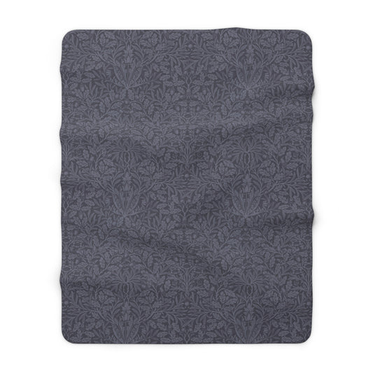 A smoky blue Sherpa fleece blanket with a floral pattern, made inspired by William Morris' Acorn and Oak Leaves collection.