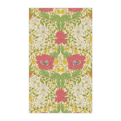 A kitchen tea towel with a floral pattern inspired by William Morris, featuring honeysuckle designs in red, yellow, and green on a light background.