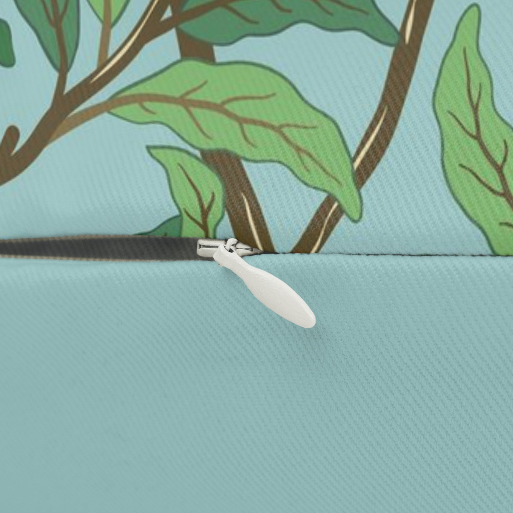 A rectangular lumbar cushion with a William Morris & Co bird and pomegranate print on a tiffany blue background, featuring a concealed zipper.