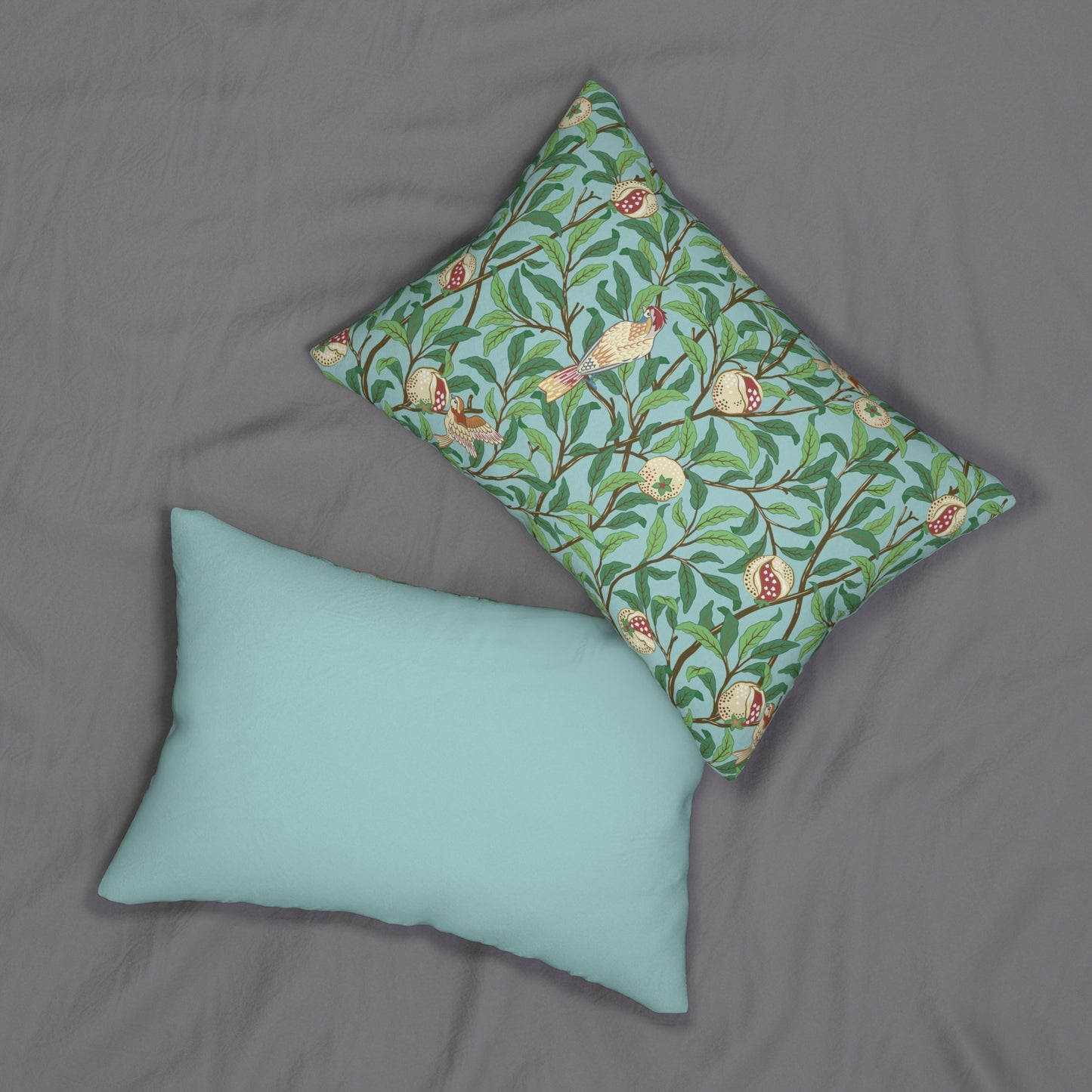 A rectangular lumbar cushion with a William Morris & Co bird and pomegranate print on a tiffany blue background, featuring a concealed zipper.