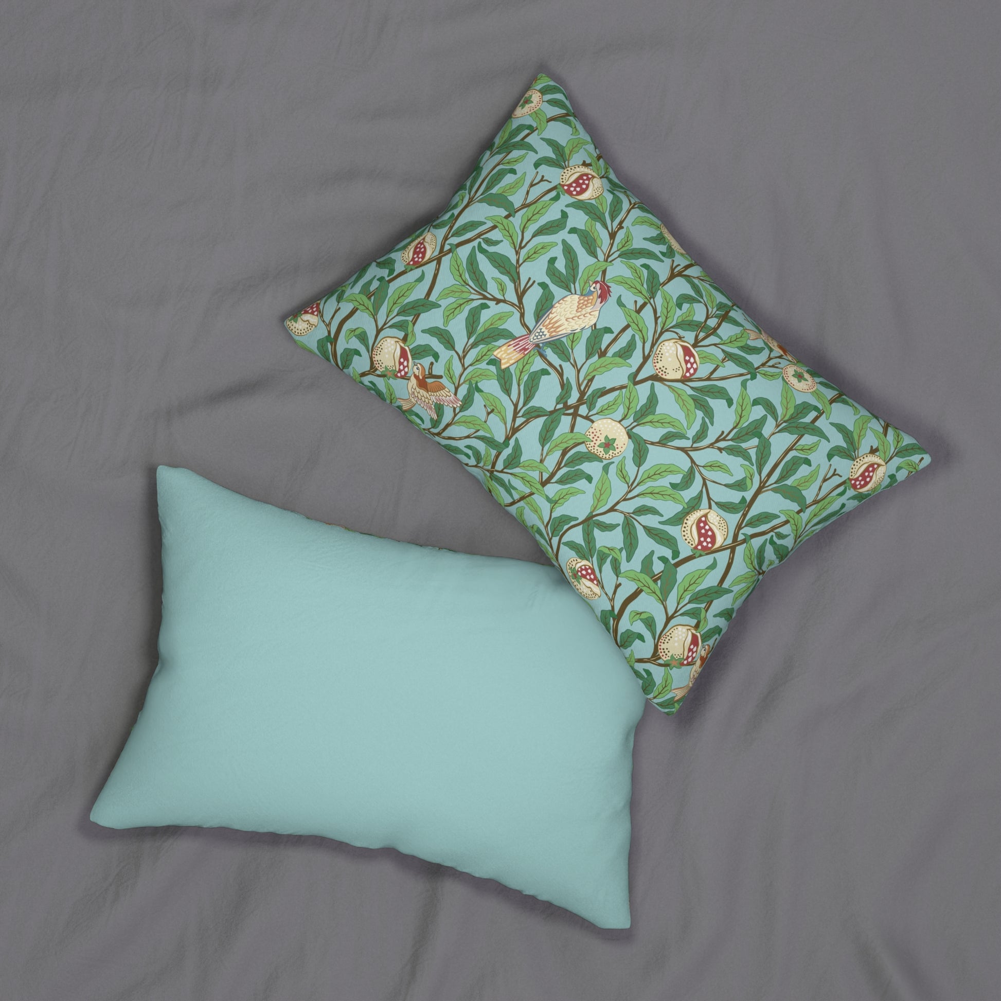 A rectangular lumbar cushion with a William Morris & Co bird and pomegranate print on a tiffany blue background, featuring a concealed zipper.