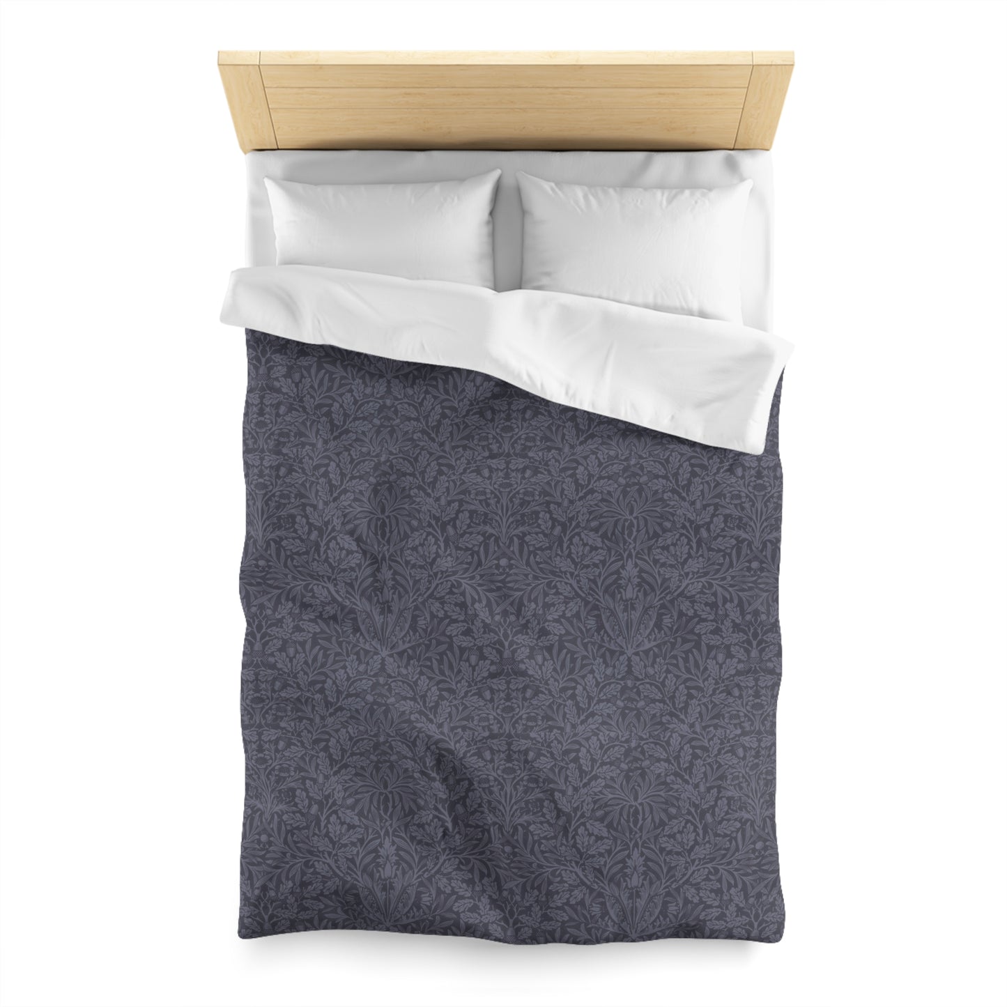 Gray patterned duvet cover with white pillowcase on a wooden bed frame.