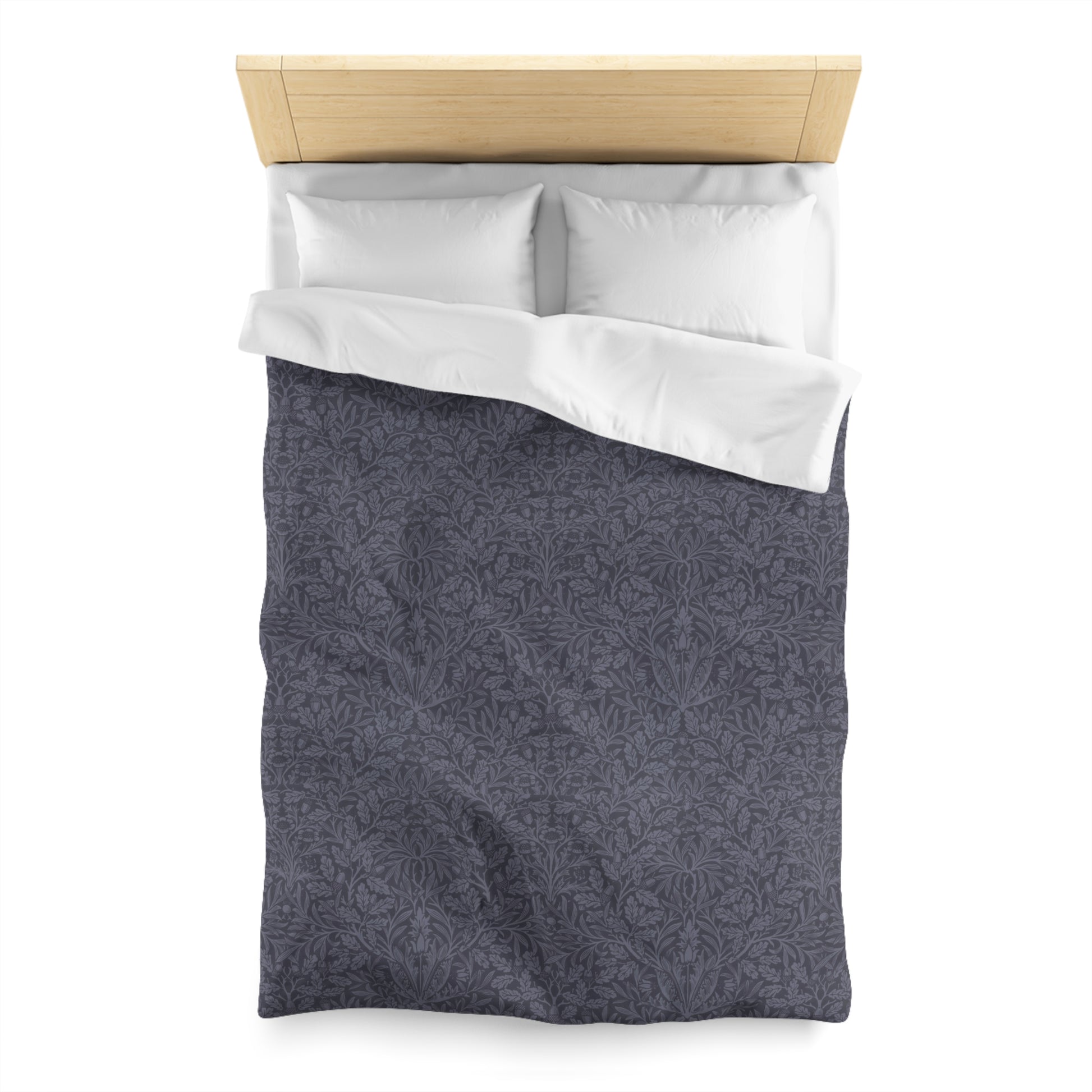 Gray patterned duvet cover with white pillowcase on a wooden bed frame.
