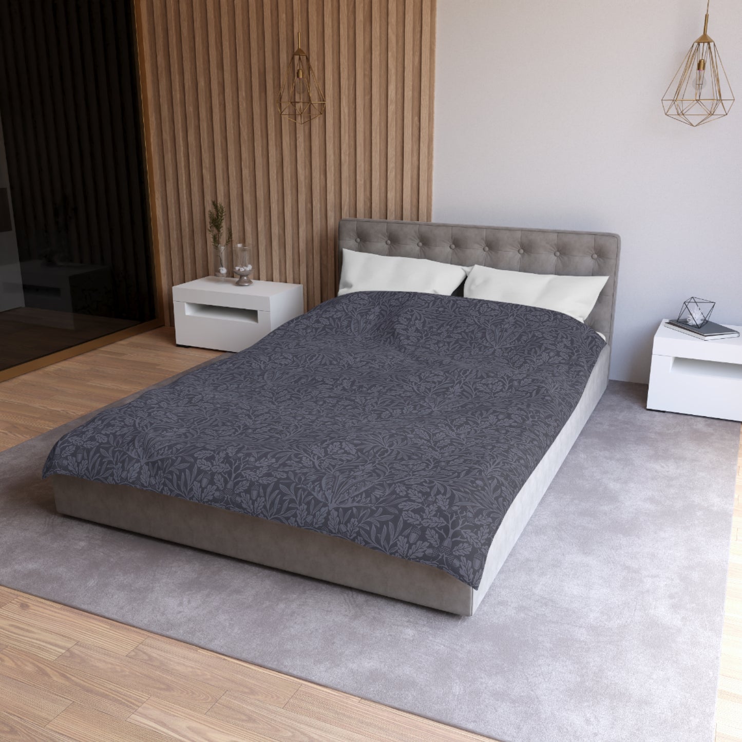 Modern bedroom with a gray bedspread on a bed, white nightstands, and wooden flooring.