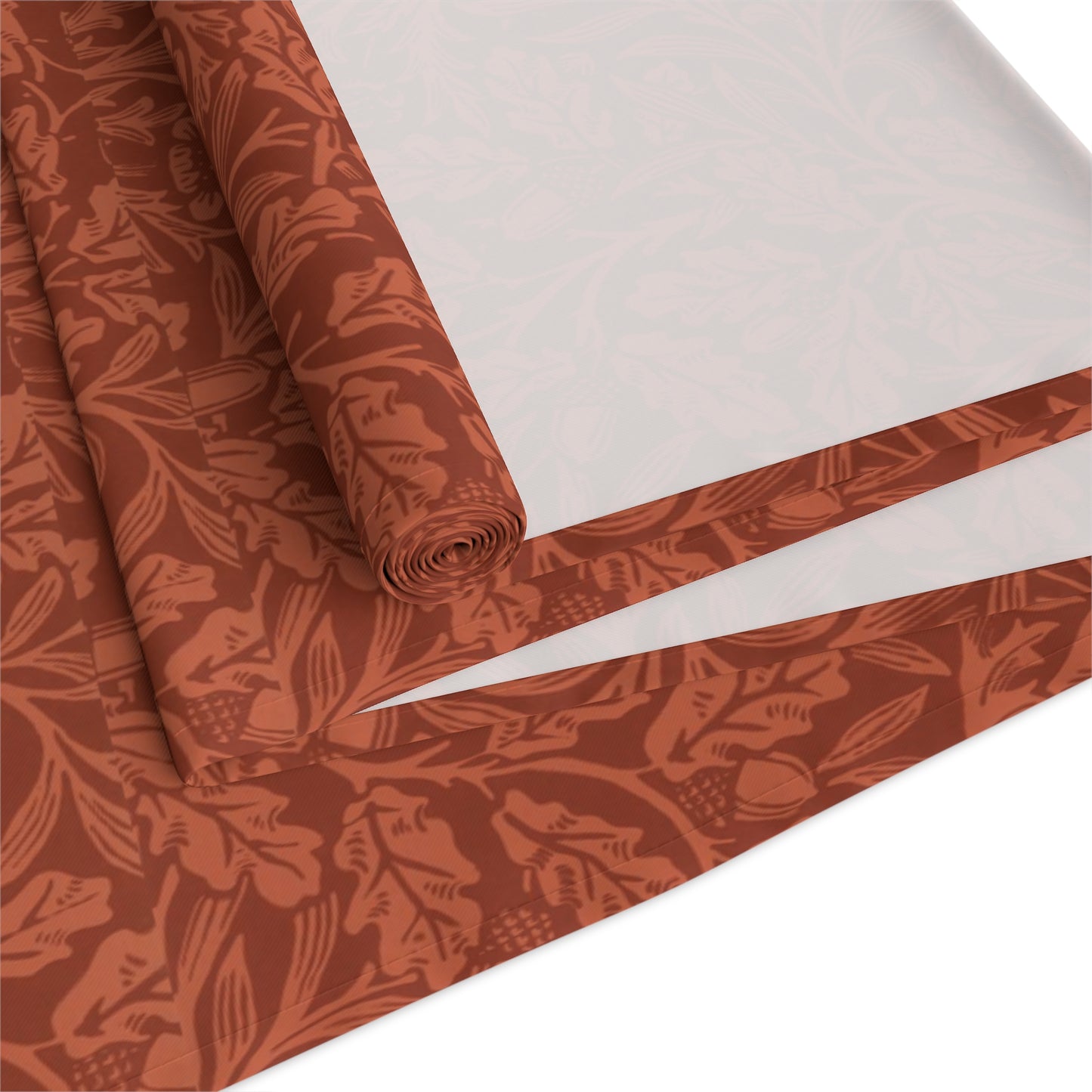 A rust-coloured table runner with a floral William Morris & Co pattern displayed on a dining table.