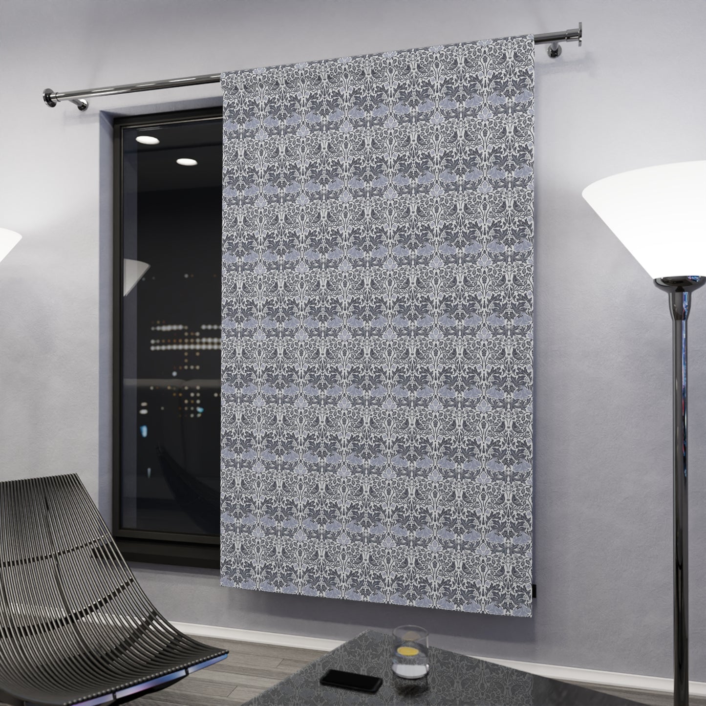 Decorative gray curtain with white pattern in a modern room setting.