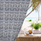 Decorative curtain with floral pattern on a beach setting