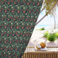 Floral patterned curtain with a beach view in the background