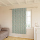Floral patterned roller blind in a room with a sofa and window.