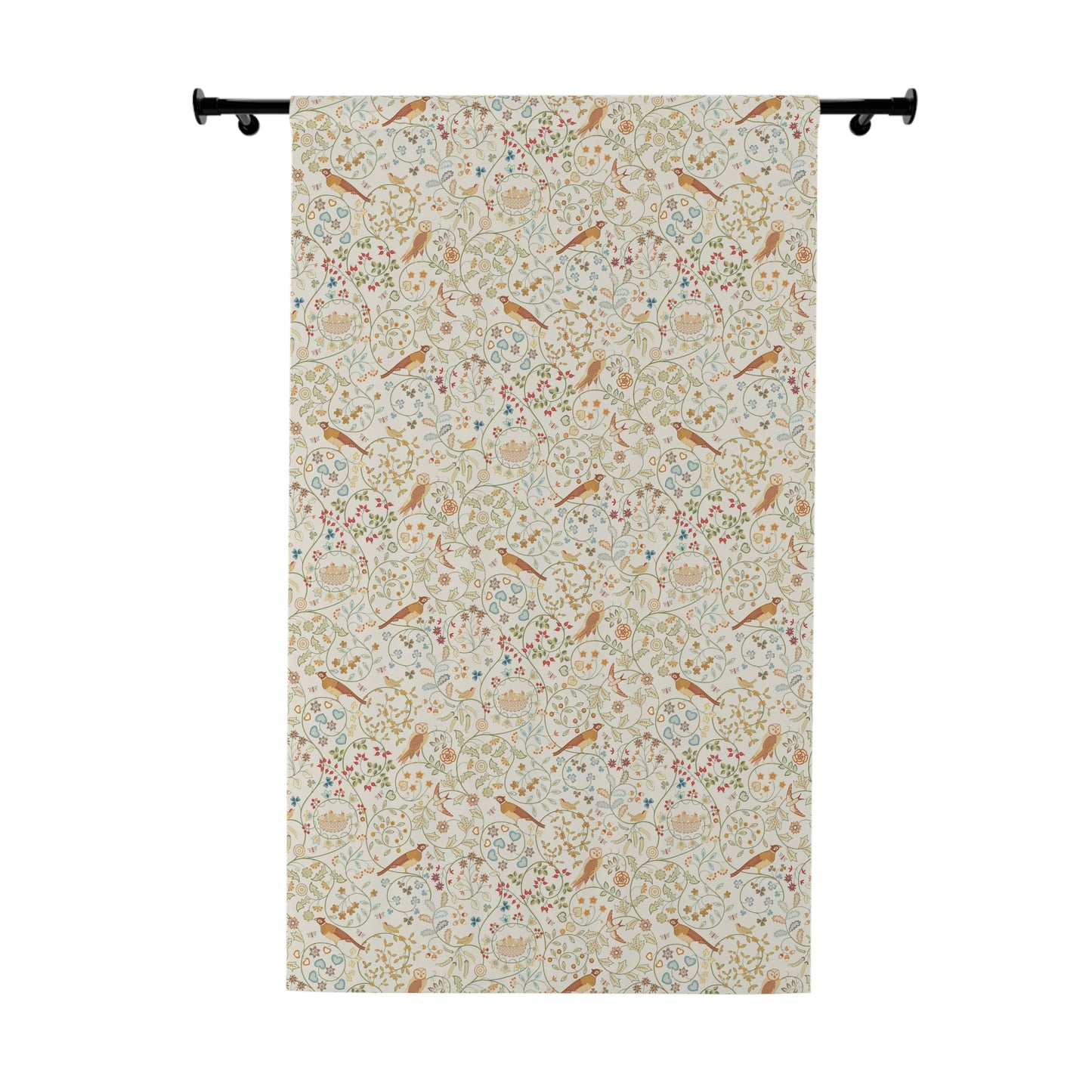 Floral and bird patterned fabric hanging on a rod against a white background