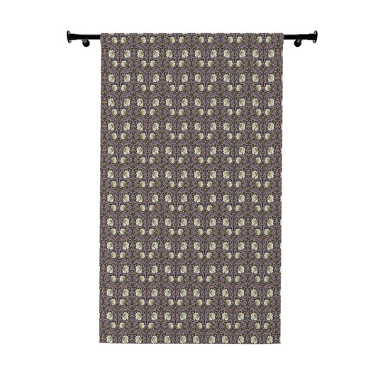 Patterned curtain hanging on a rod against a white background