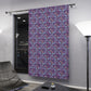 Decorative purple curtain with floral pattern hanging in a room.