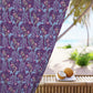 Floral patterned fabric draped over a chair with a beach setting in the background