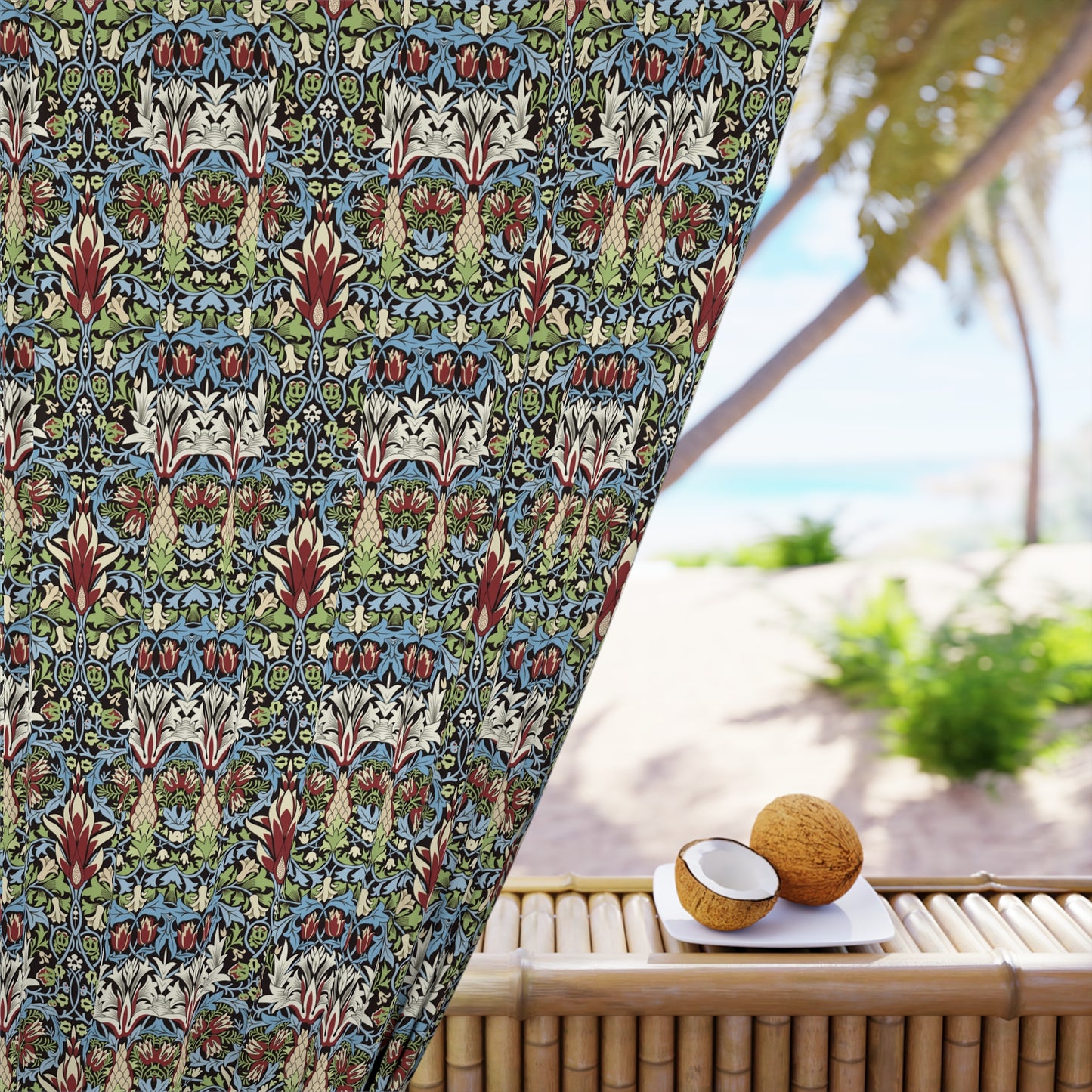 Decorative outdoor curtain with a colorful pattern next to a table with coconuts on a patio.