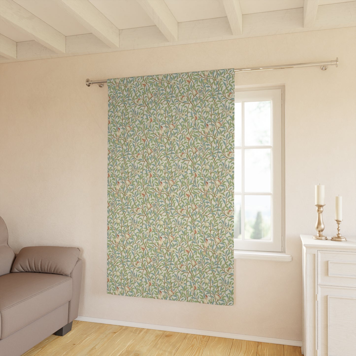 Floral patterned curtain hanging in a room with a sofa and window.