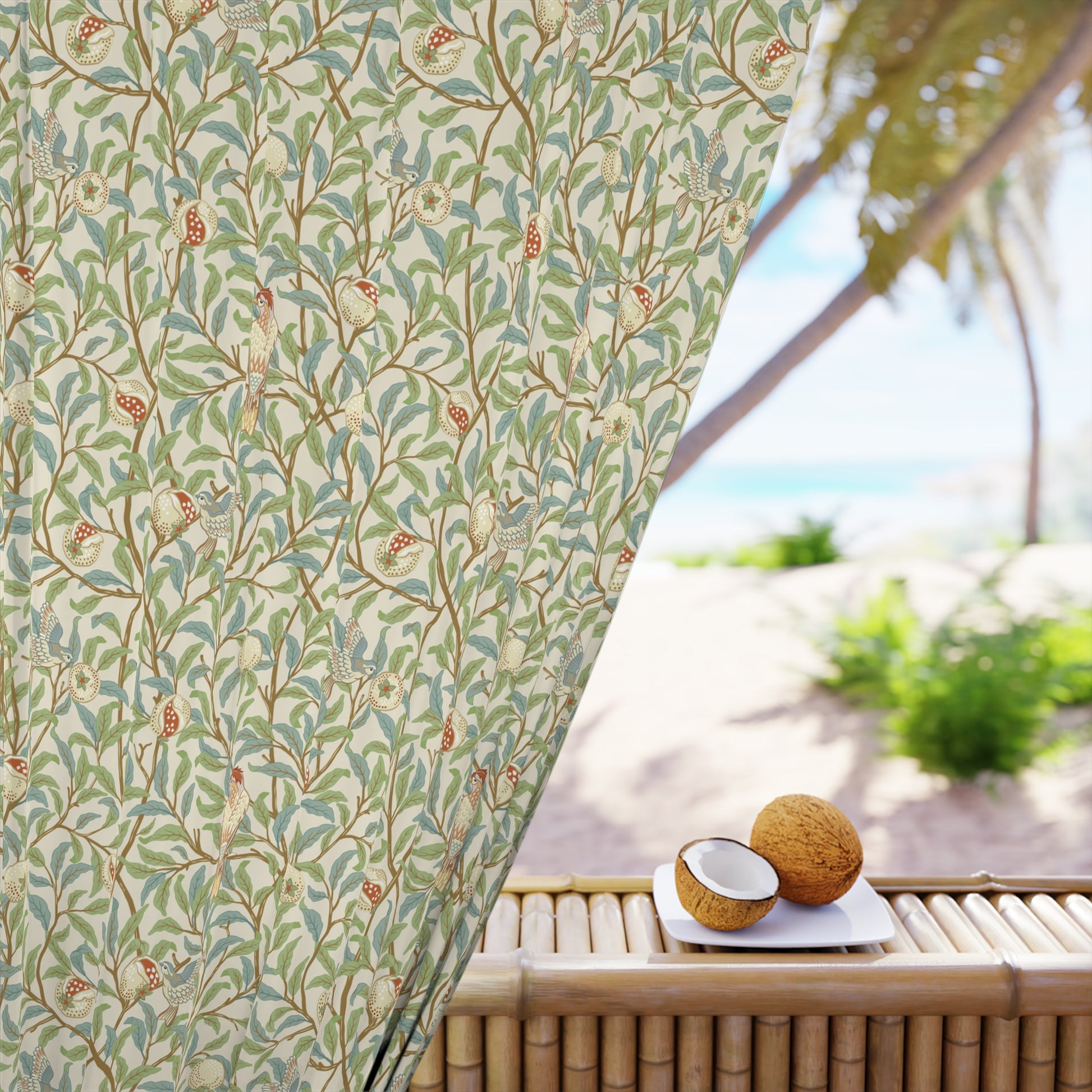 Decorative curtain with floral pattern in front of a beach view