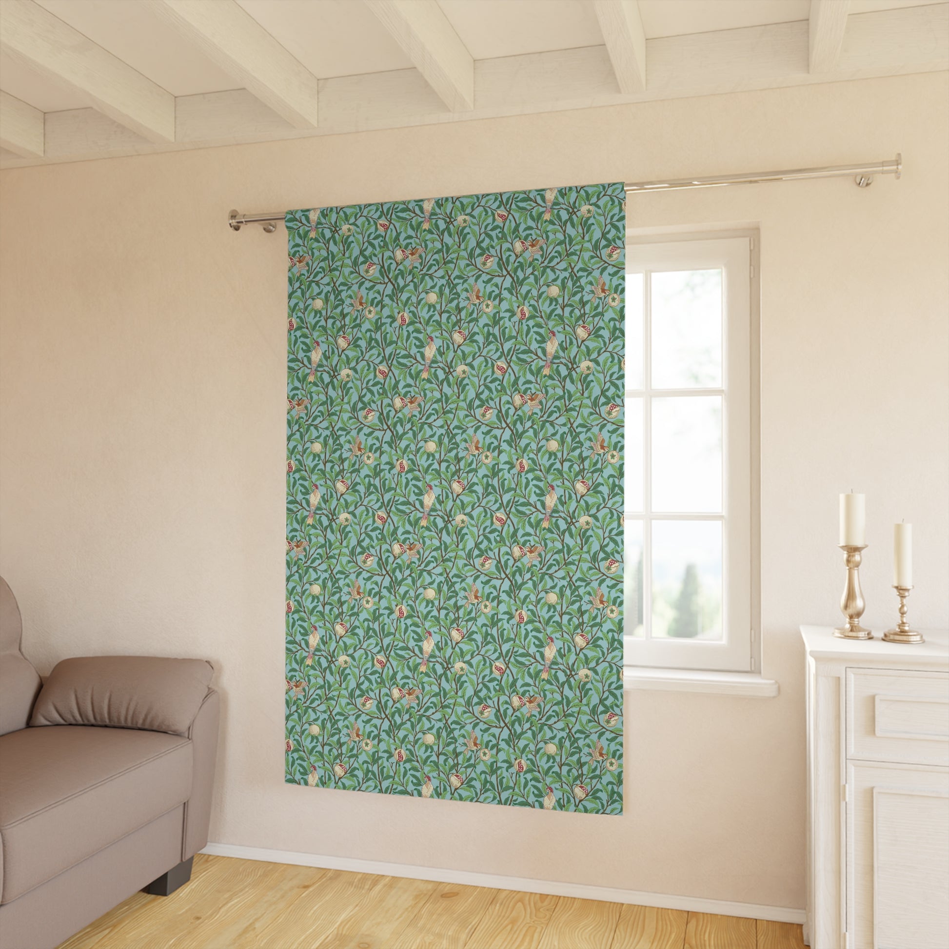 Floral patterned curtain on a window in a room with a sofa and cabinet.