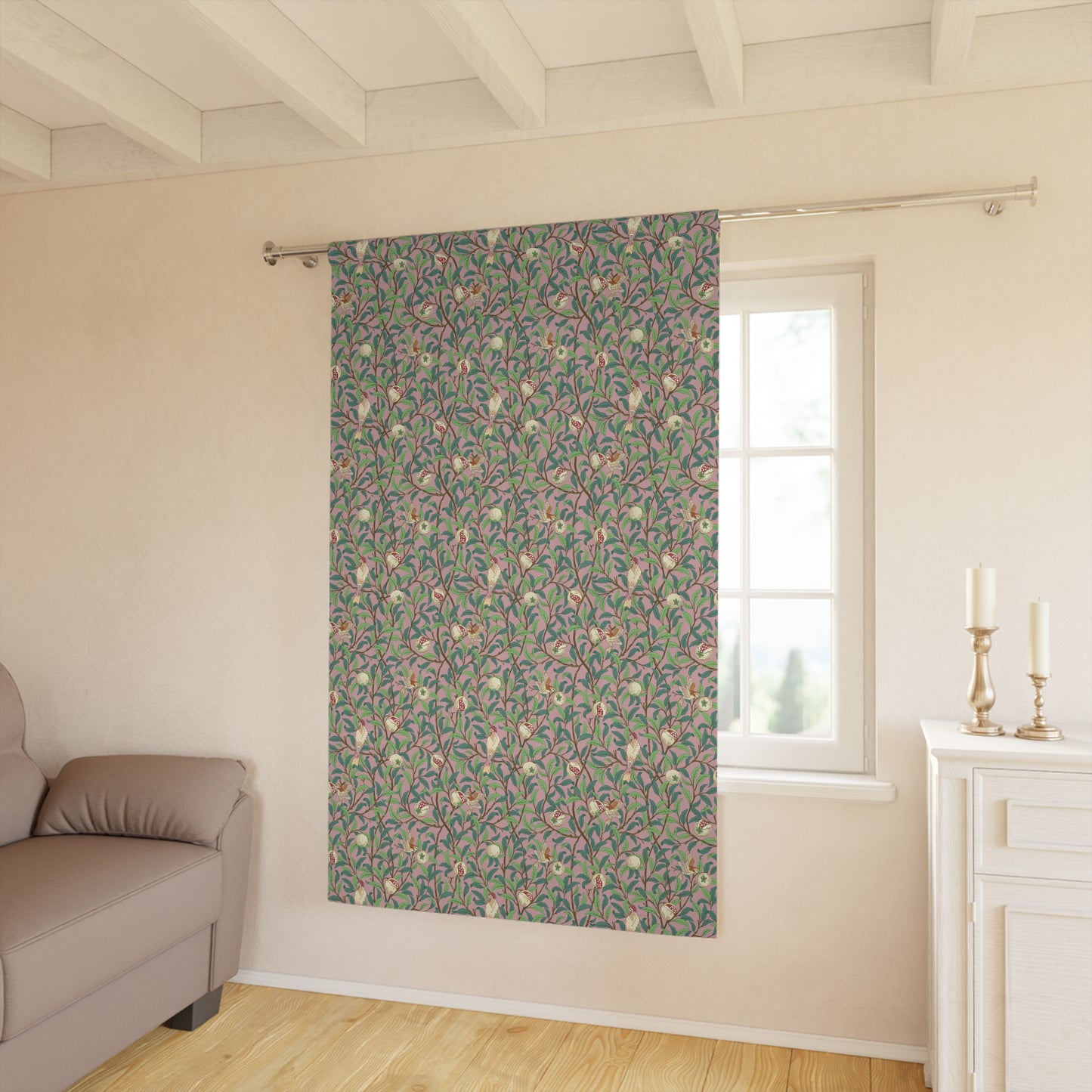 Floral patterned curtain hanging in a room with a sofa and window.
