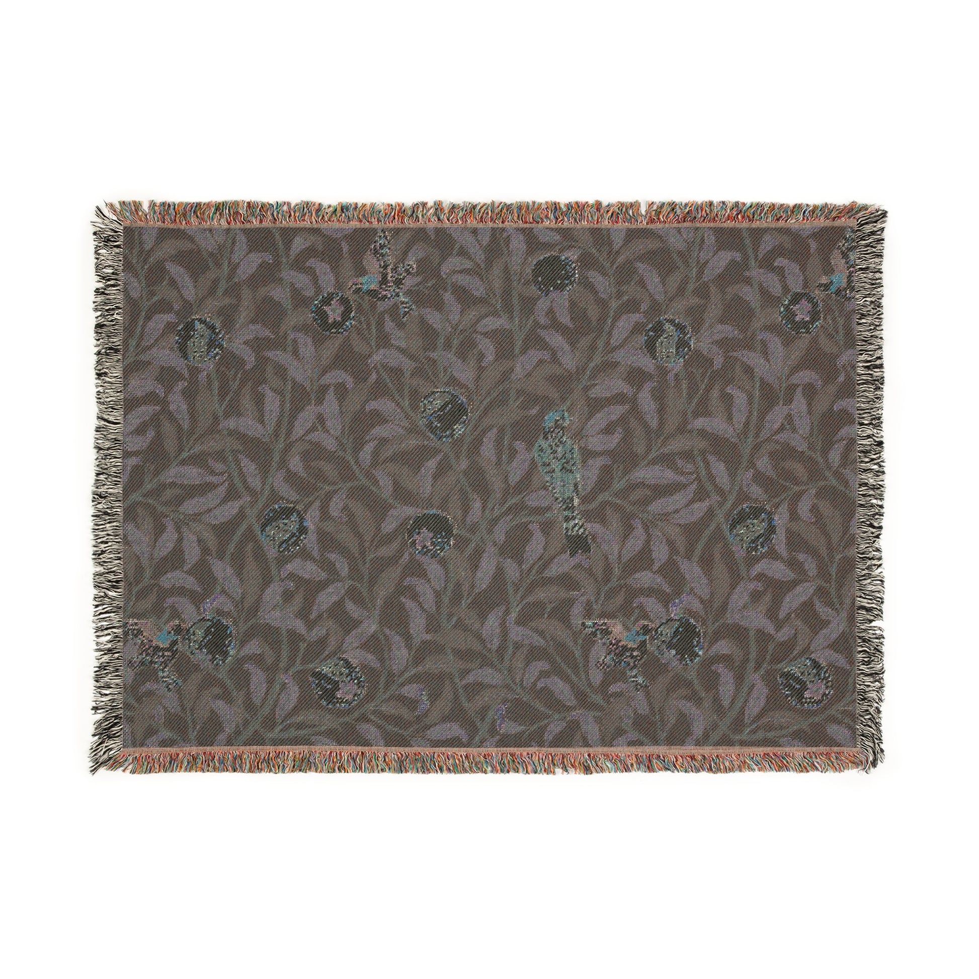 A woven cotton blanket with a geometric William Morris & Co pattern featuring birds and pomegranates in a onyx black colour, with fringed edges.