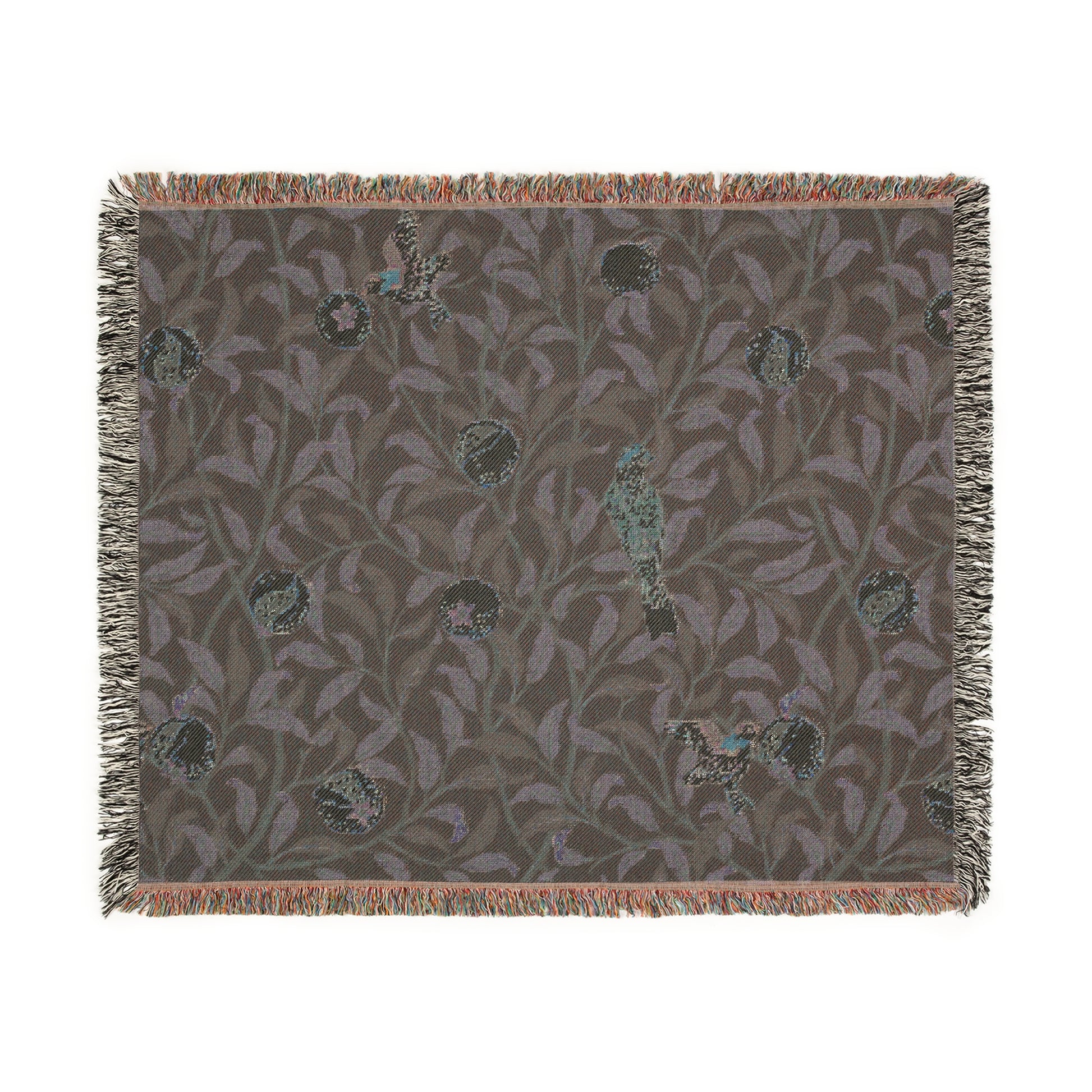 A woven cotton blanket with a geometric William Morris & Co pattern featuring birds and pomegranates in a onyx black colour, with fringed edges.