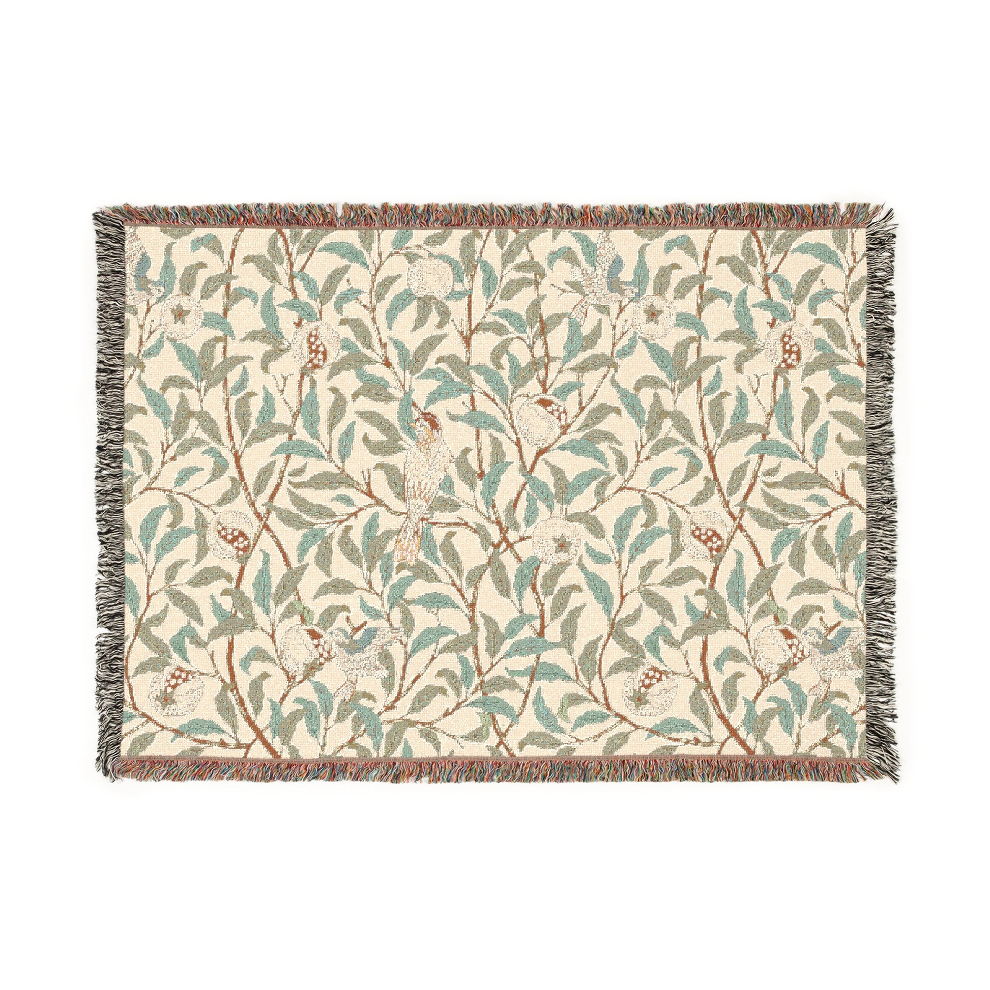 A woven cotton blanket with a geometric bird and pomegranate William Morris & Co pattern in beige, green, and brown colours, with fringed edges.