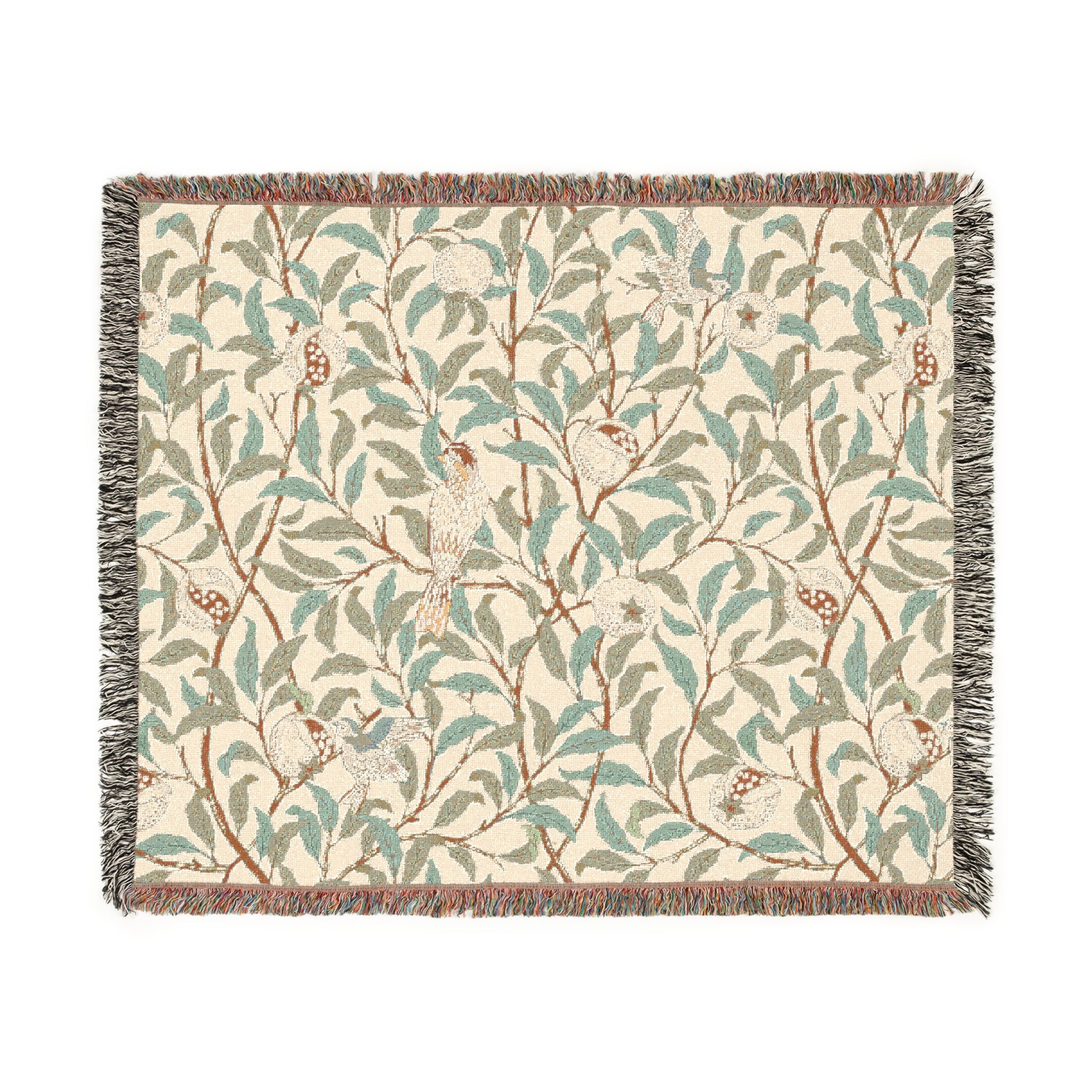 A woven cotton blanket with a geometric bird and pomegranate pattern in beige, green, and brown colors, with fringed edges.