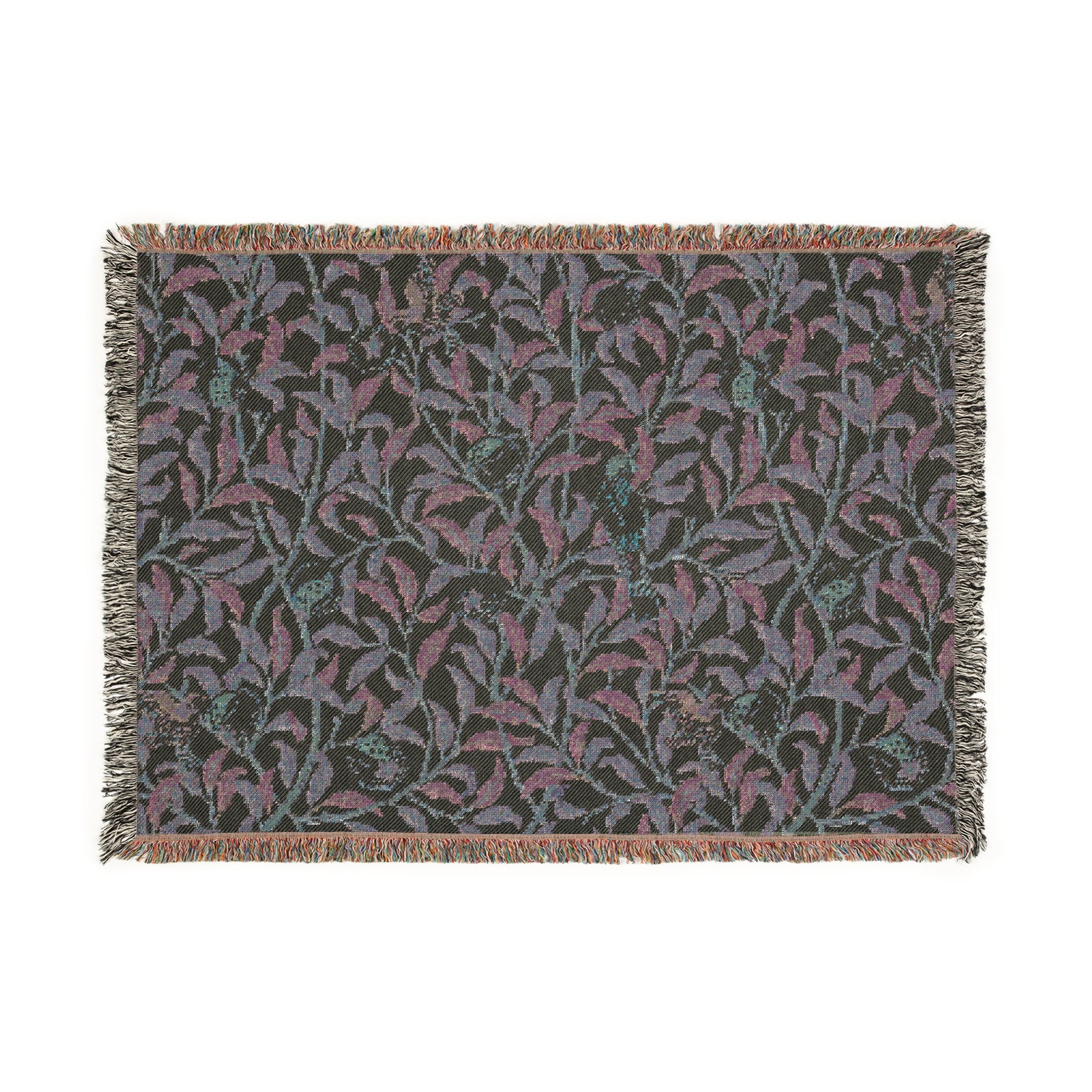 A woven cotton blanket with a geometric bird and pomegranate William Morris & Co pattern in beige, green, and brown colours, with fringed edges.