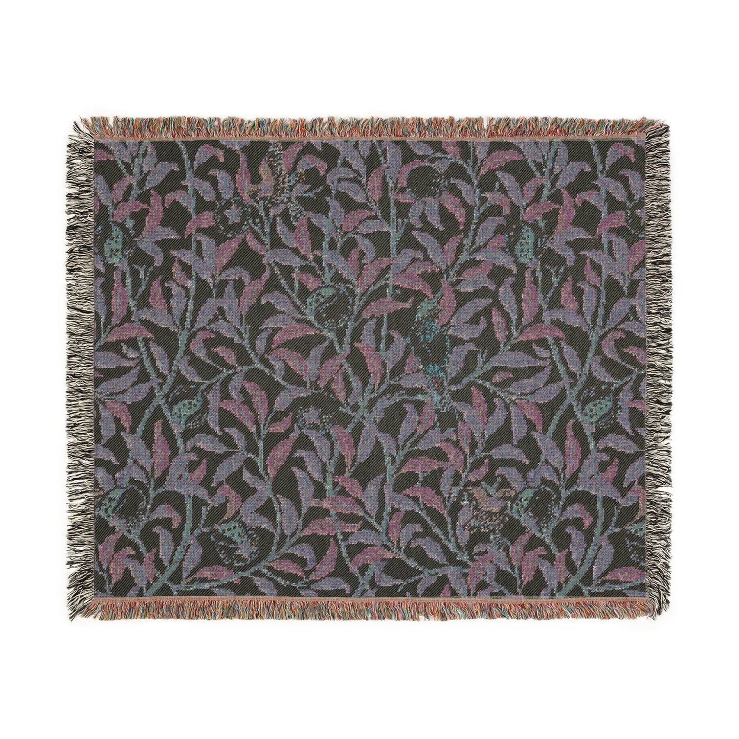 A woven cotton blanket with a geometric bird and pomegranate William Morris & Co pattern in beige, green, and brown colours, with fringed edges.