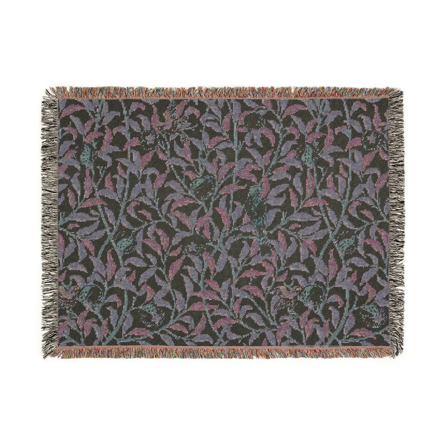 A woven cotton blanket with a geometric bird and pomegranate William Morris & Co pattern in beige, green, and brown colours, with fringed edges.