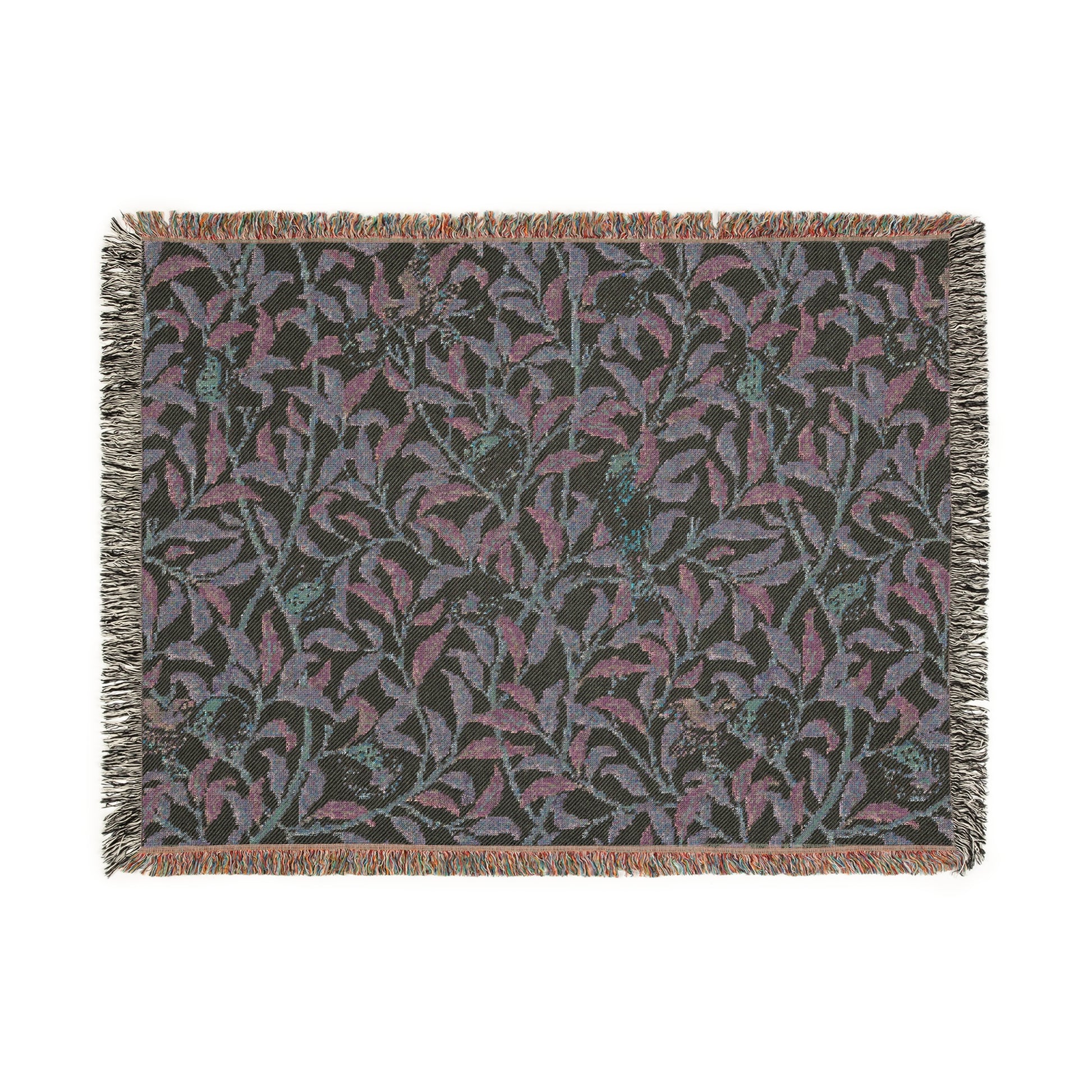 A woven cotton blanket with a geometric bird and pomegranate William Morris & Co pattern in beige, green, and brown colours, with fringed edges.