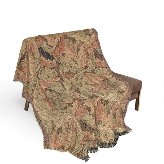 Decorative blanket with leaf pattern draped over a chair on a white background