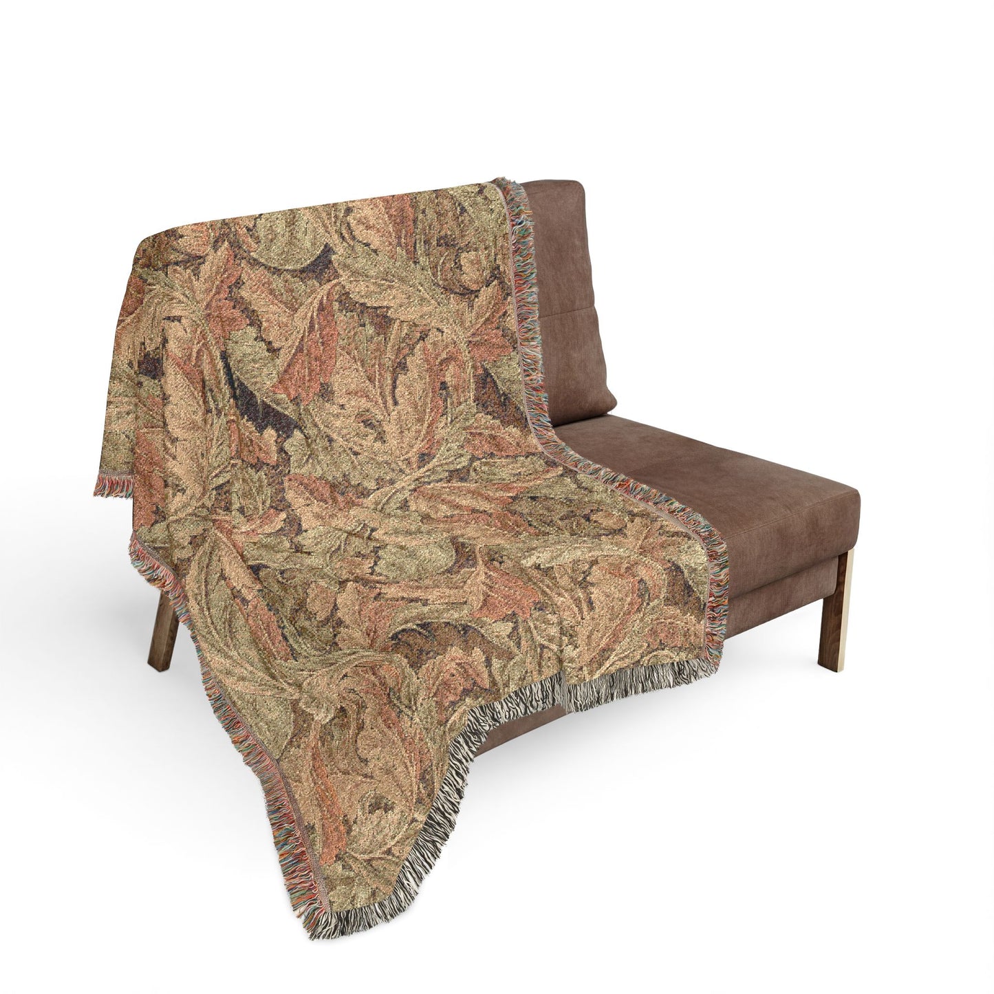 Patterned throw blanket draped over a brown chair on a white background