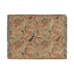 Woven blanket with leaf pattern on a white background