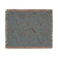 Patterned throw blanket with fringe on a white background