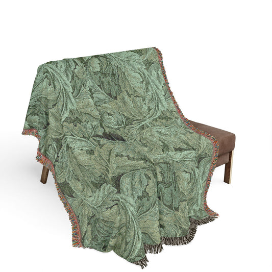 Floral patterned blanket draped over a chair on a white background
