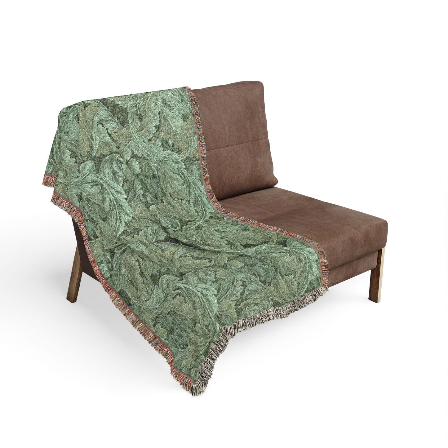 Green patterned throw blanket draped over a brown chair on a white background