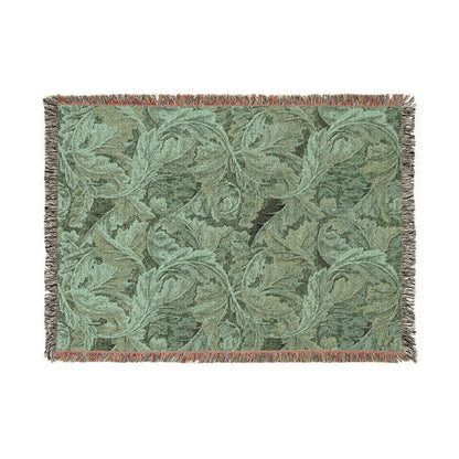 Green woven blanket with leaf pattern on a white background