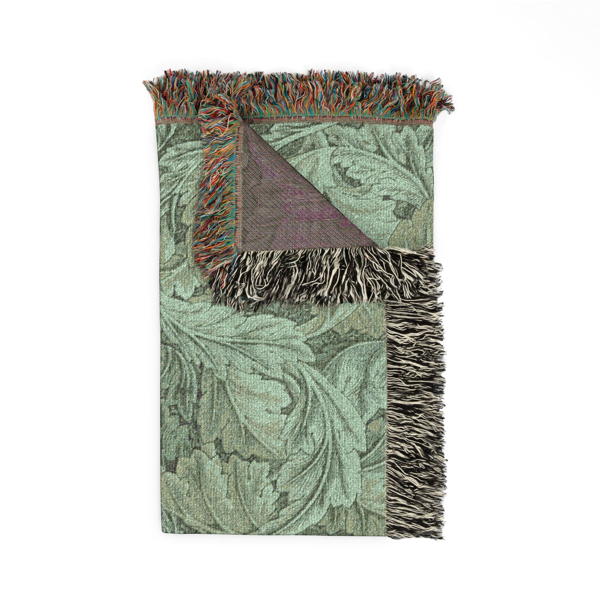 Green patterned throw blanket with fringed edges on a white background