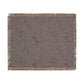 Floral patterned throw blanket with fringe on a white background