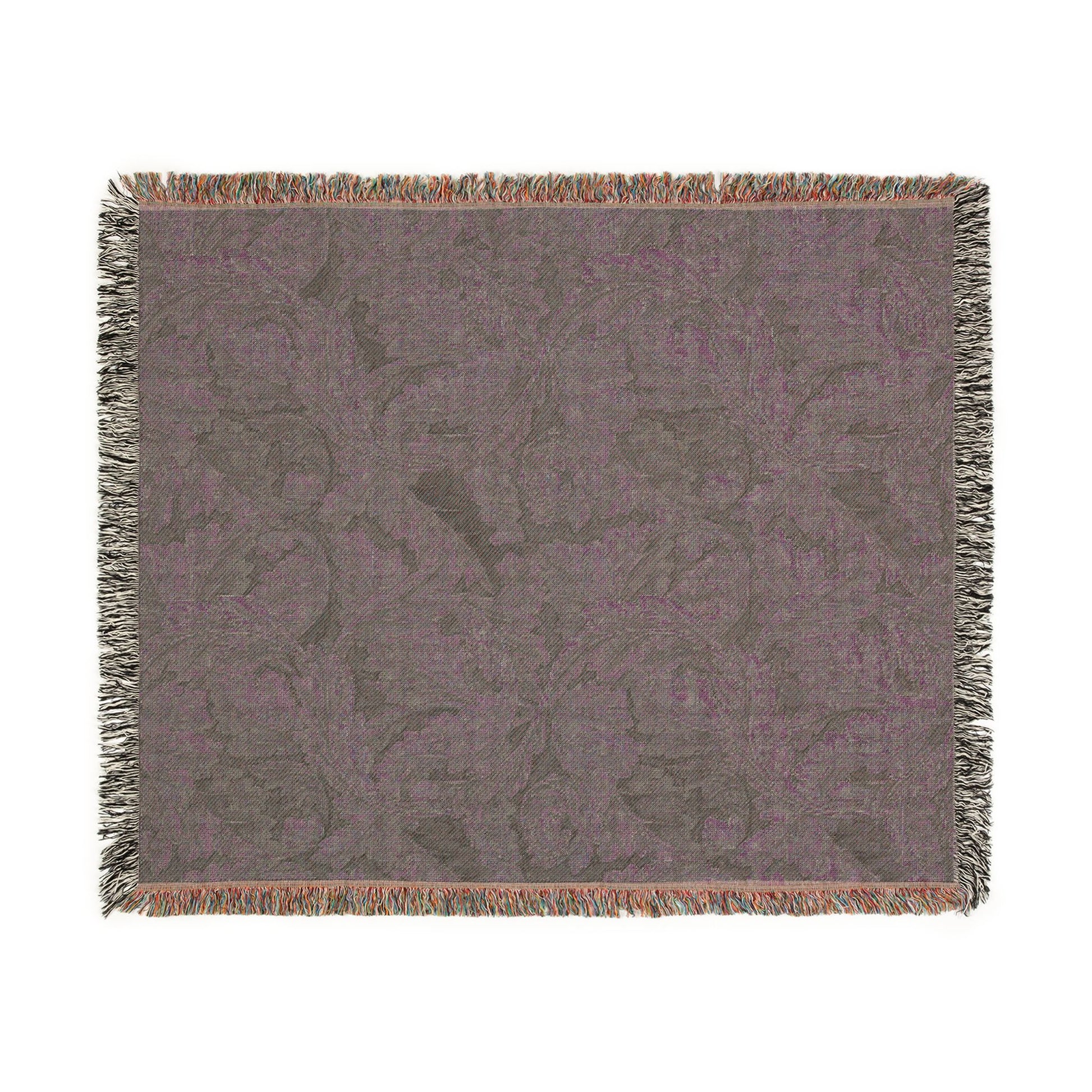 Floral patterned throw blanket with fringe on a white background