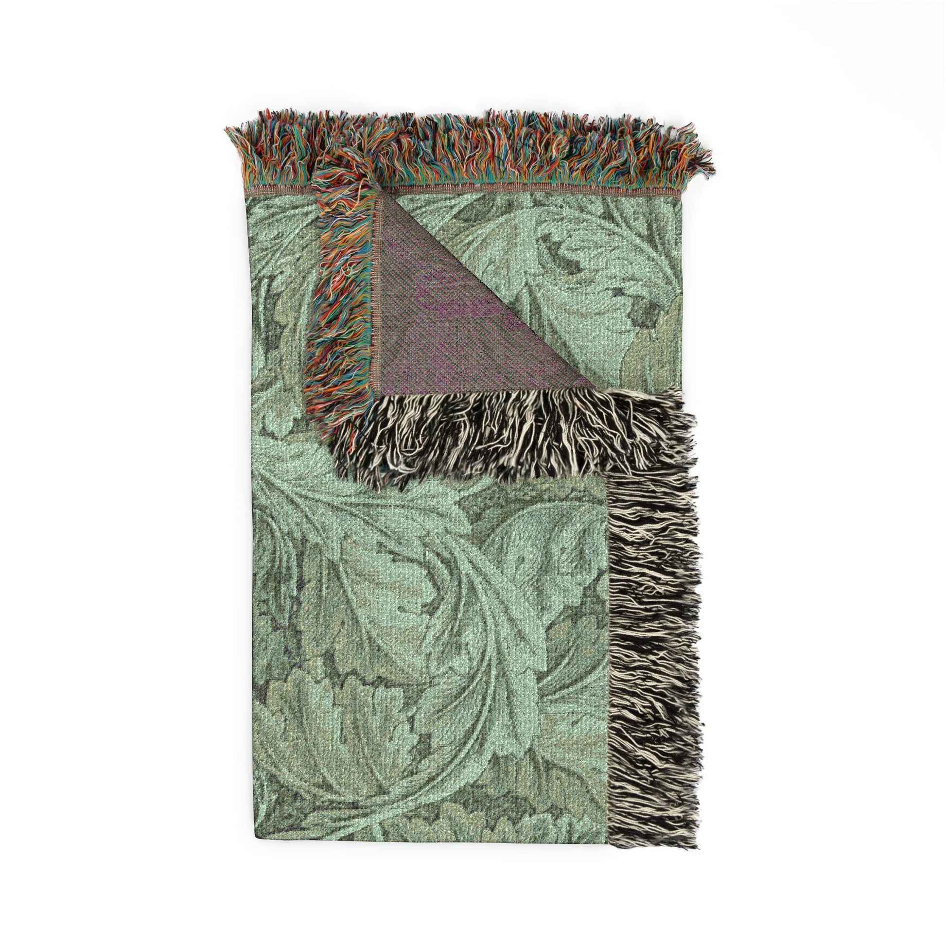 Decorative throw blanket with intricate pattern and fringed edges on a white background