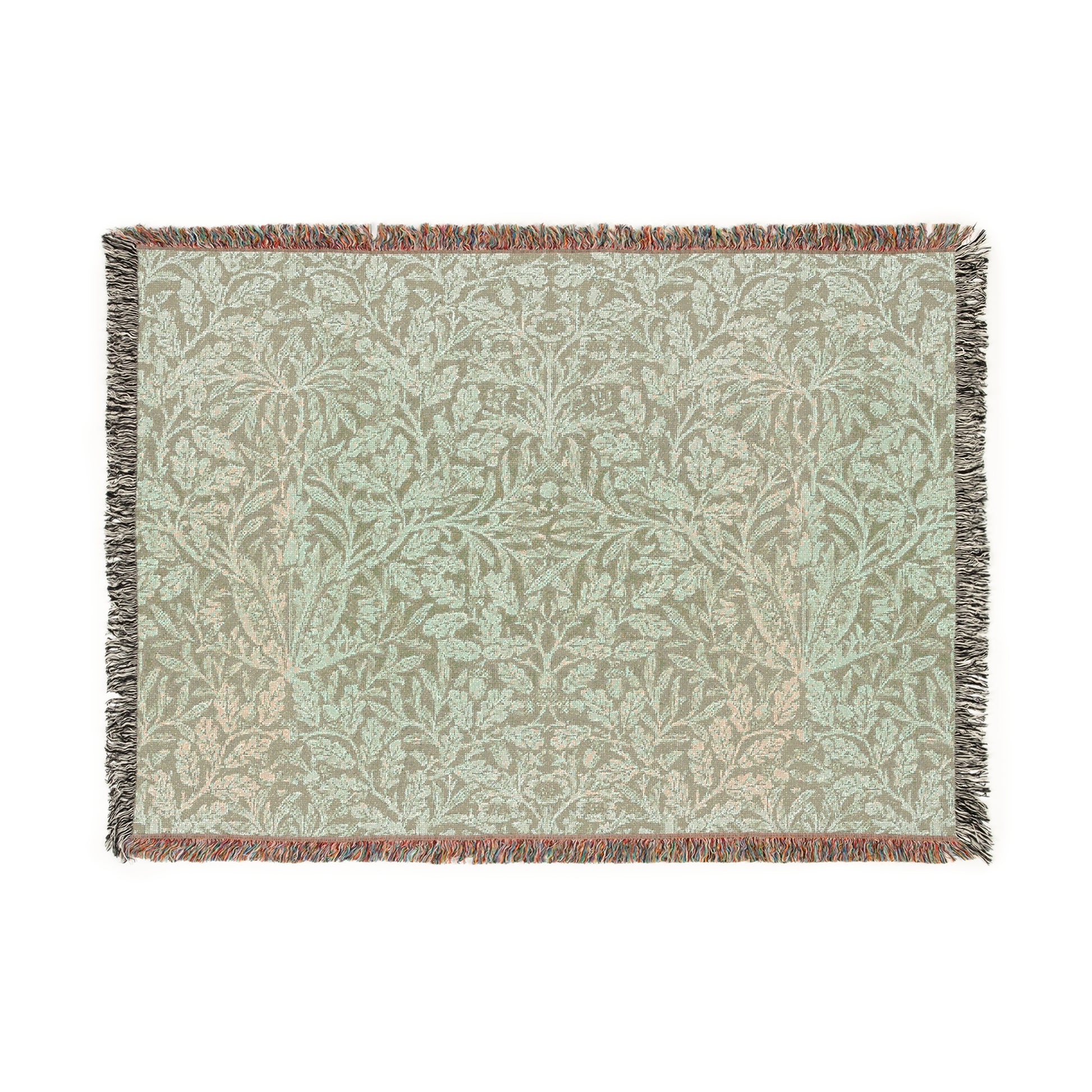 A green woven blanket with a floral pattern and colorful fringed edges displayed on a plain background.