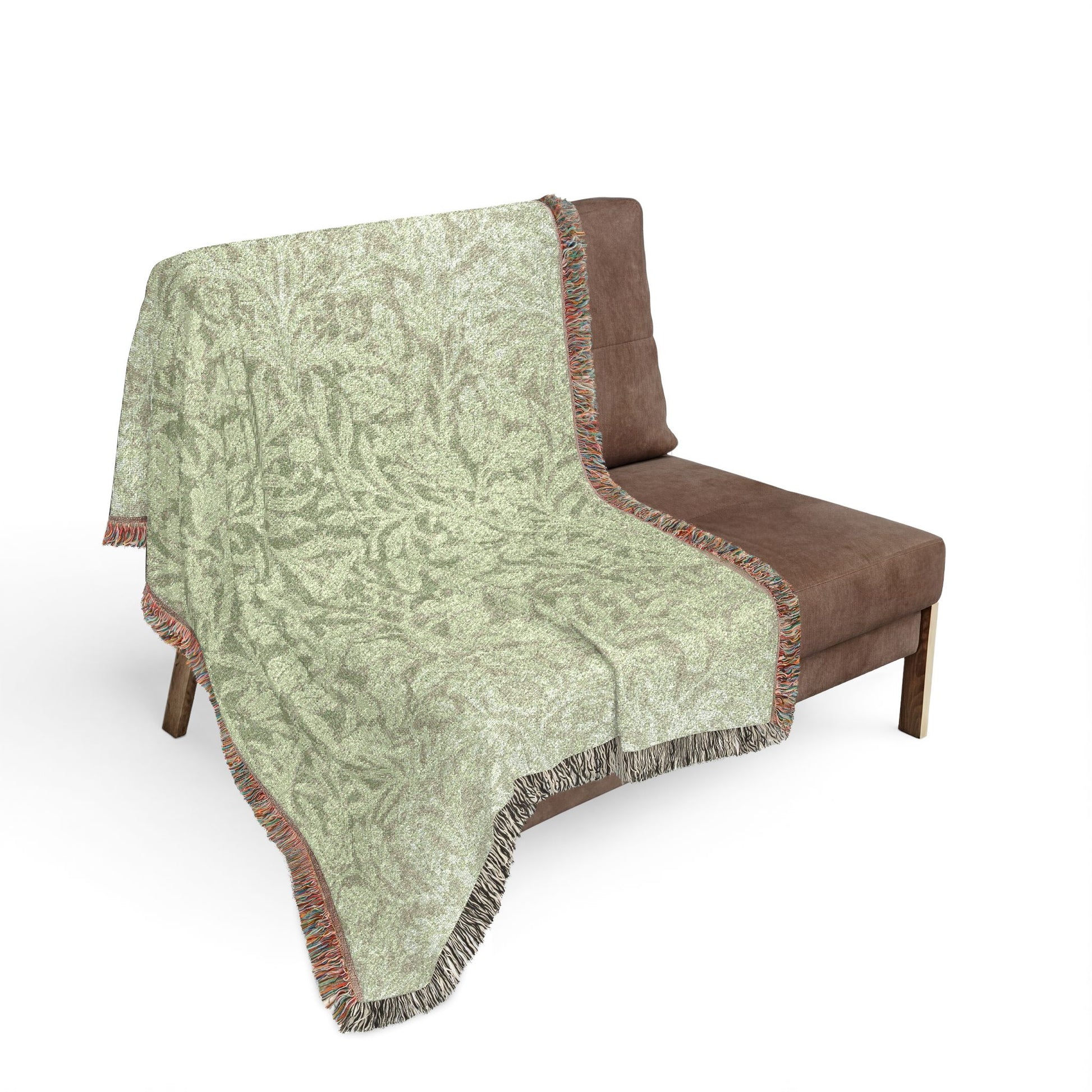 Patterned blanket draped over a brown chair on a white background