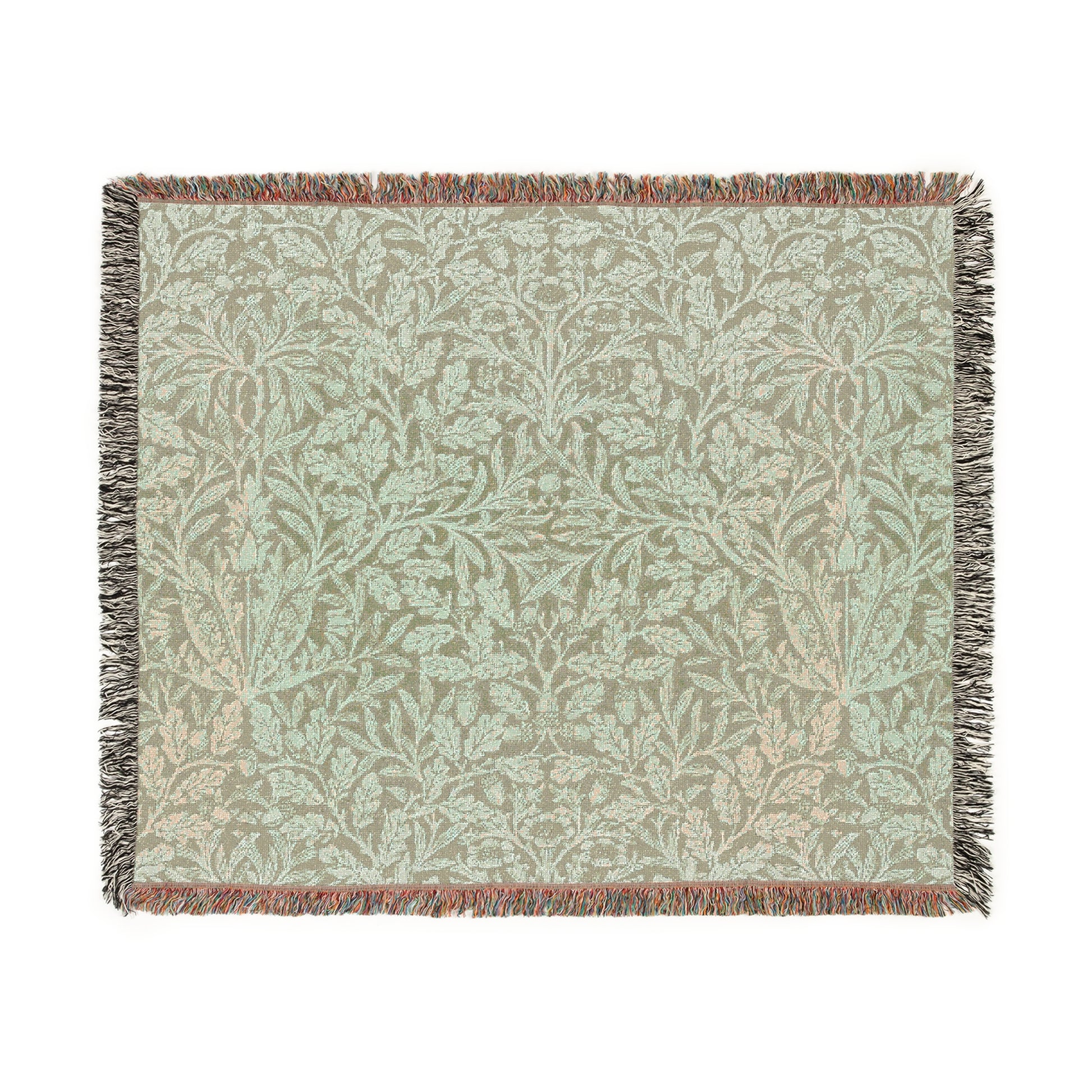 A green woven blanket with a floral pattern and colorful fringed edges displayed on a plain background.